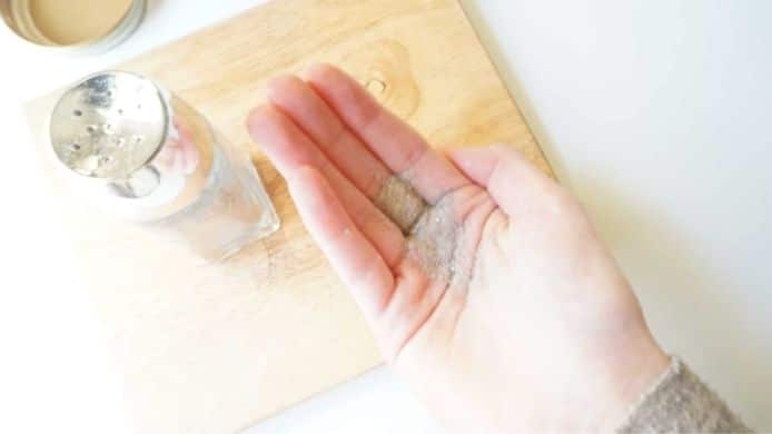 Dry Shampoo DIY recipe shaken out into a woman's hand.