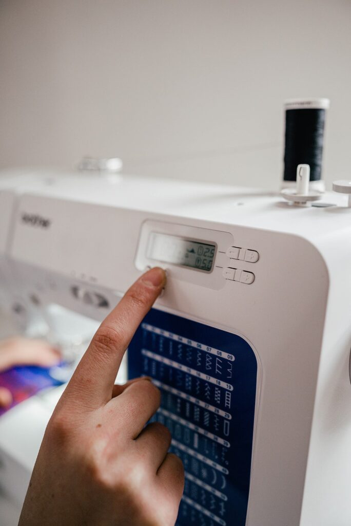 Beginner sewing a cloth napkin at home as part of a zero waste lifestyle.